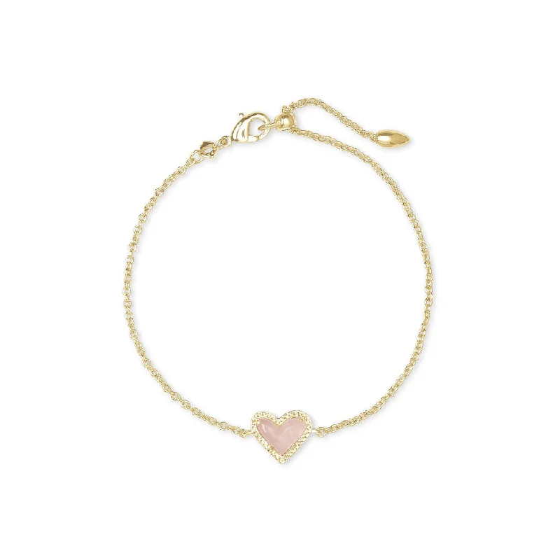 Silver bangles with polished mirror finish shine -Kendra Scott Ari Heart Gold Delicate Chain Bracelet in Rose Quartz